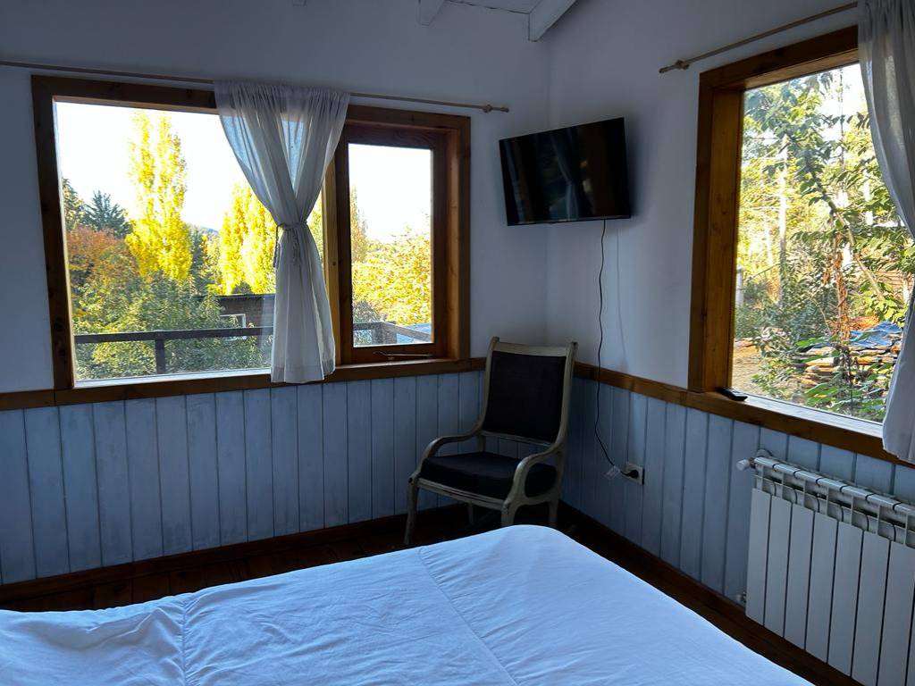 Bedroom with windows and TV