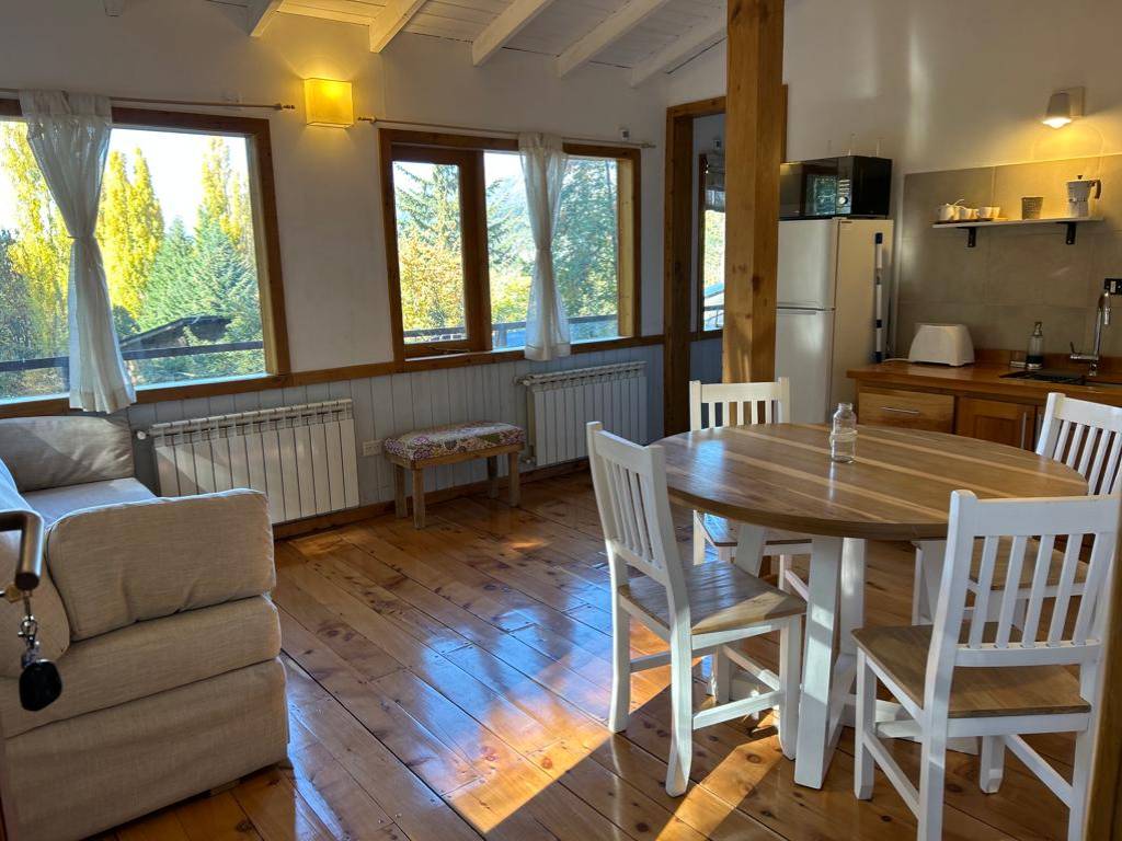 Living and dining room with round table and large windows