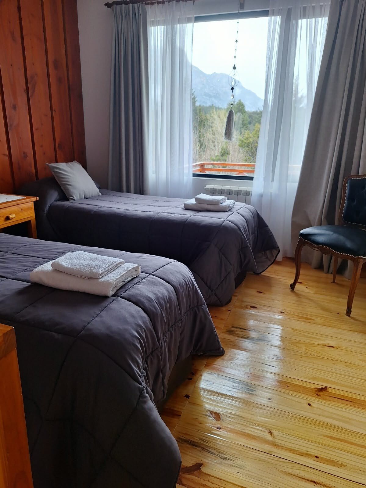 Bedroom with single beds and mountain views