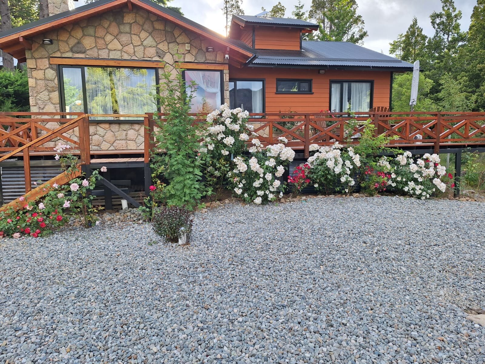The stone-and-timber house with its deck