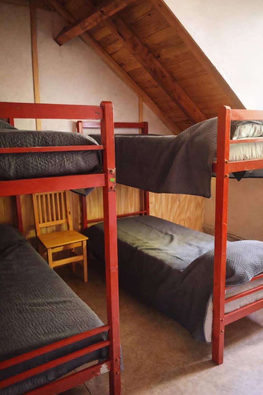 Two bunk beds in a room with a sloping ceiling