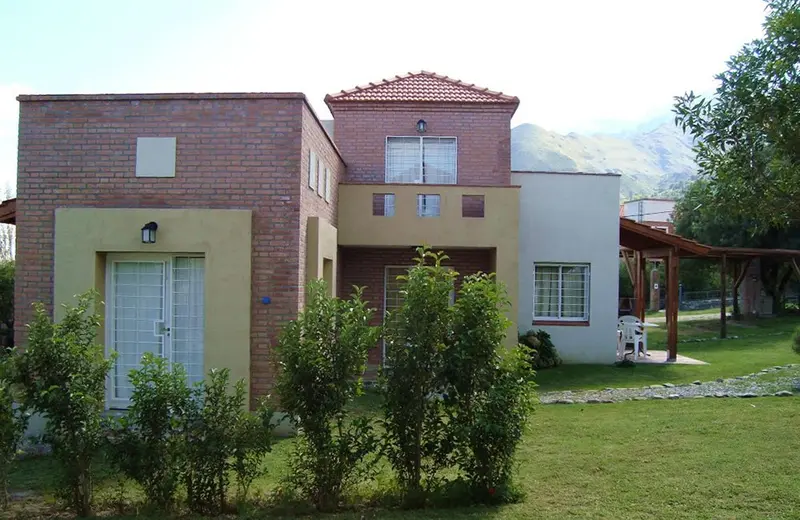 Cabaña con jardín y la sierra detrás